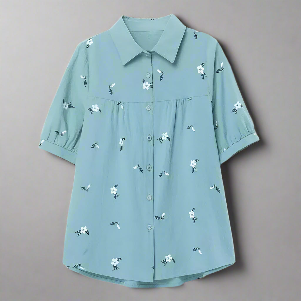 Light blue shirt with floral patterns on a white background